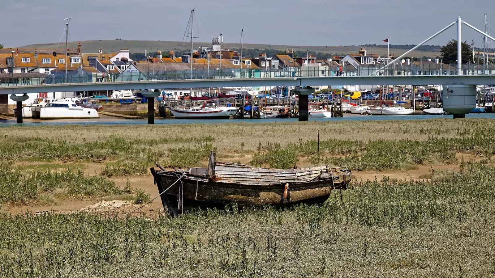 An abandoned wooden boat at a mooring