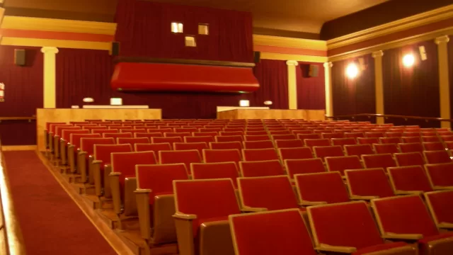 Empty cinema auditorium with red seats