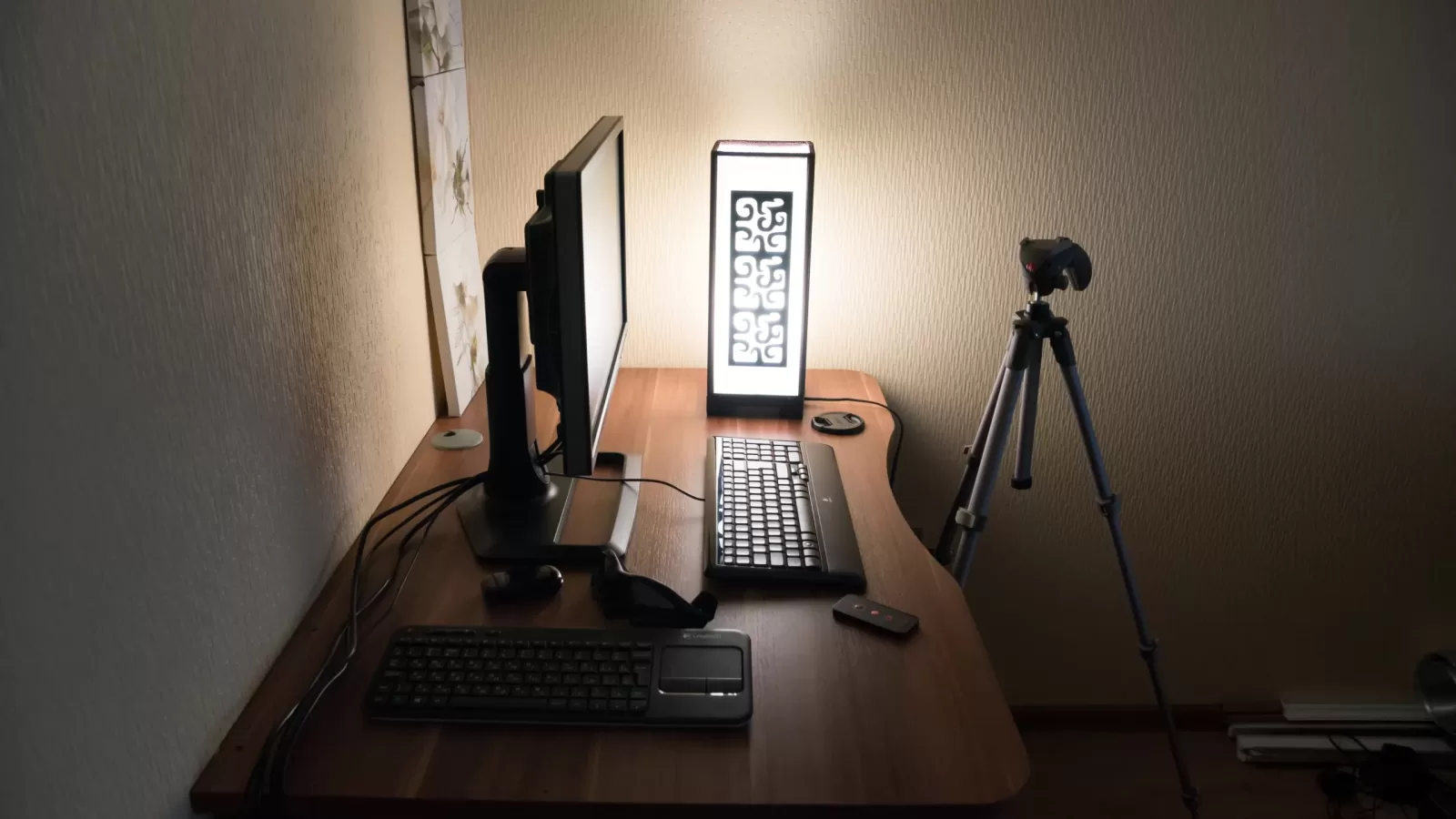A computer desk with a monitor and keyboard