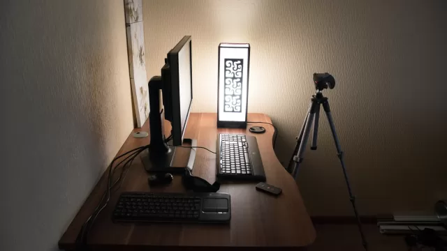 A computer desk with a monitor and keyboard
