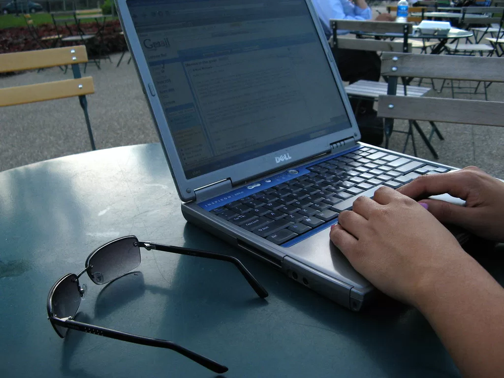 A laptop open on an email inbox outdoors