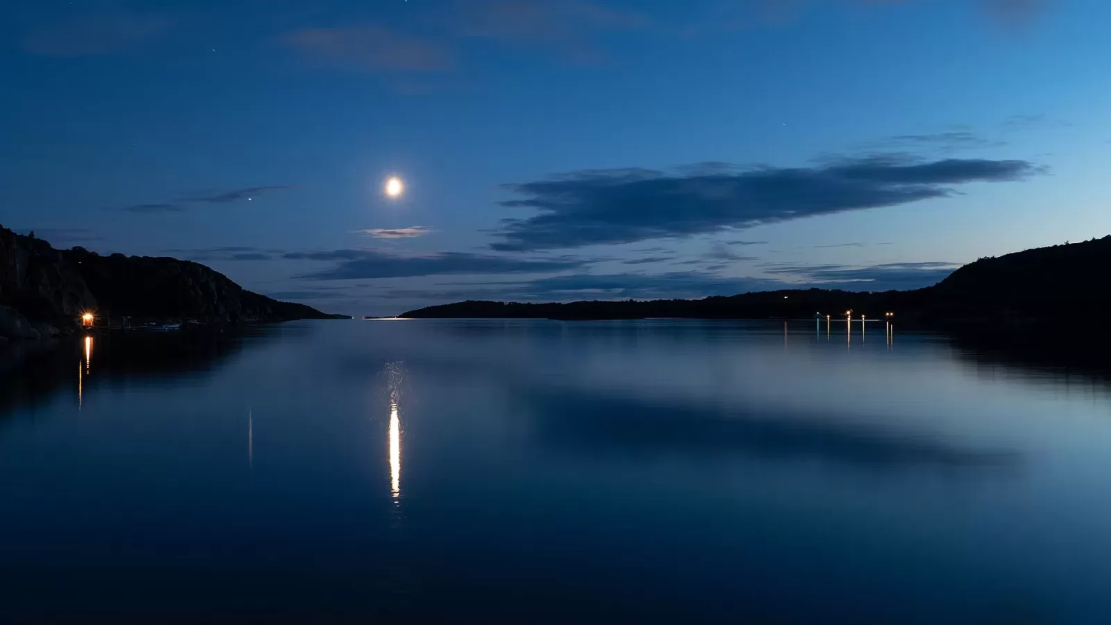 The moon above water at night