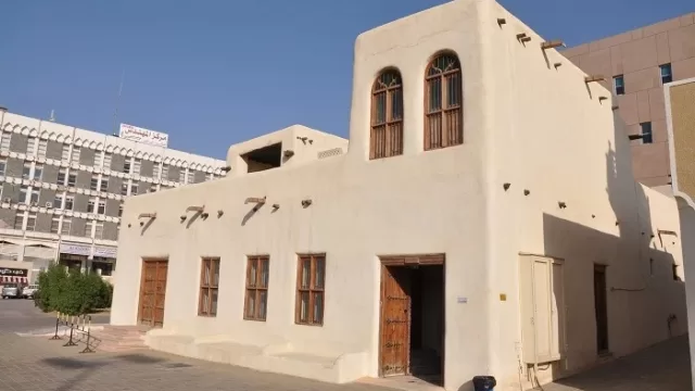 The mud-brick exterior of a traditional Kuwaiti house
