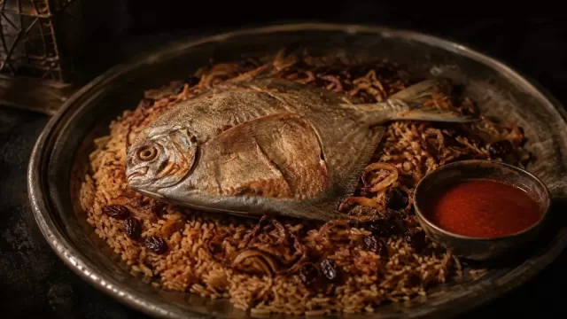 A plate of fish served over spiced rice