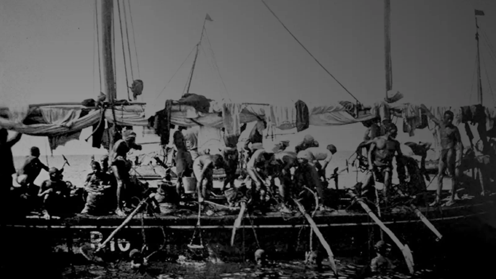 An archive photograph of pearl divers working from a boat in the Gulf