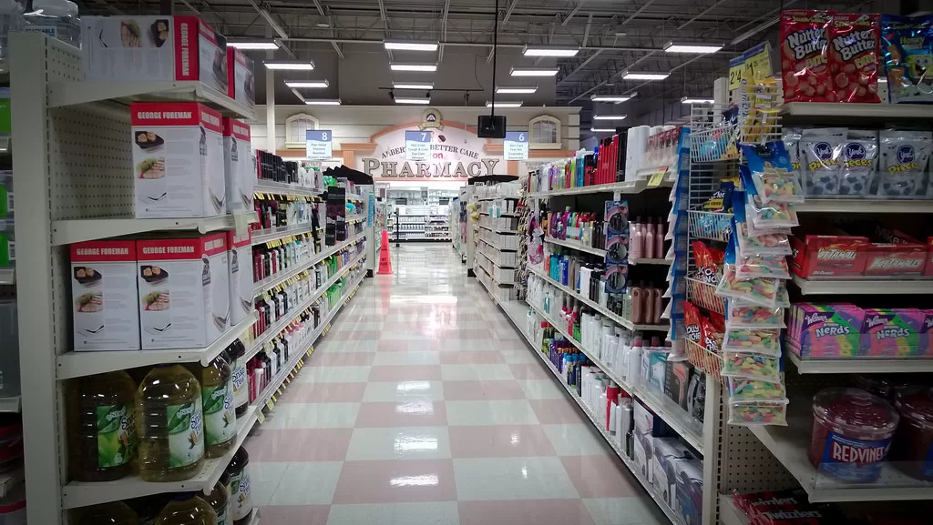 Shelves of medicine in a pharmacy aisle