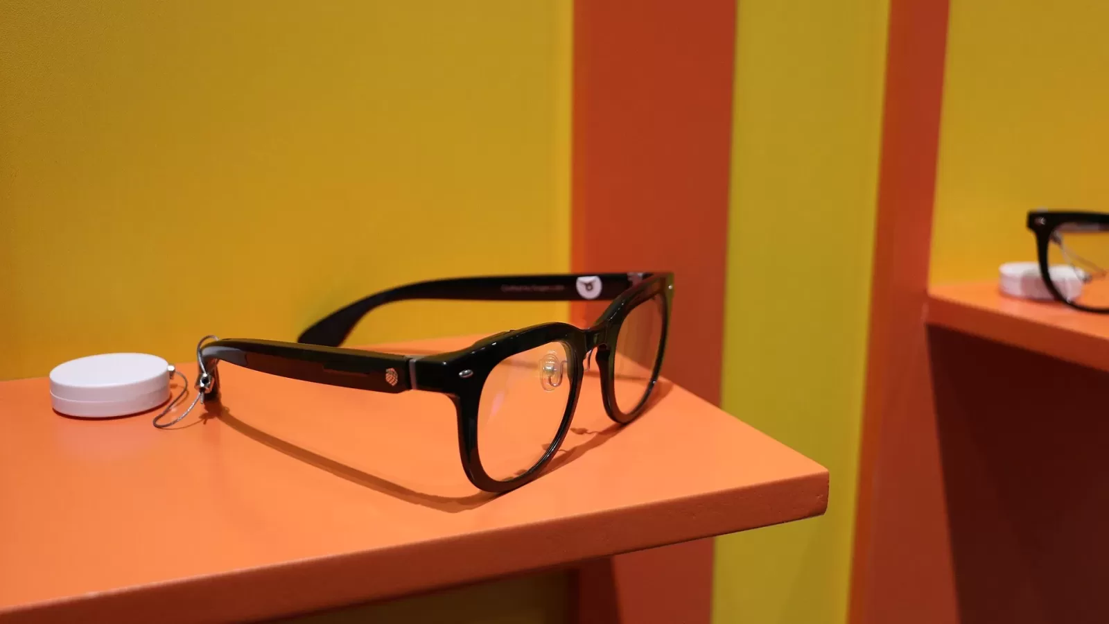 A pair of smart glasses displayed on a table