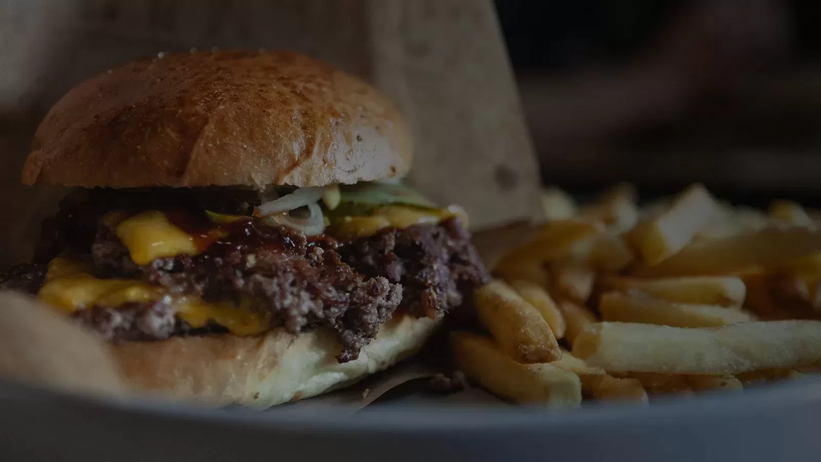 A smash burger served with a portion of fries