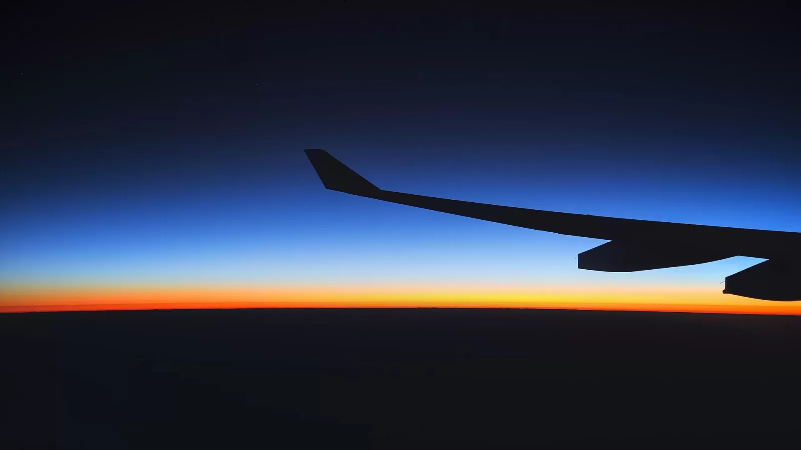 An aircraft wing at sunrise