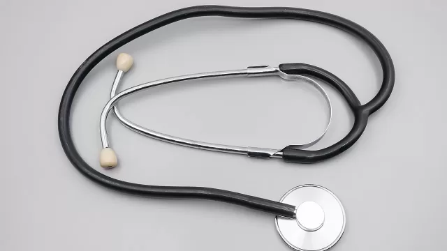 A doctor stethoscope on a plain surface