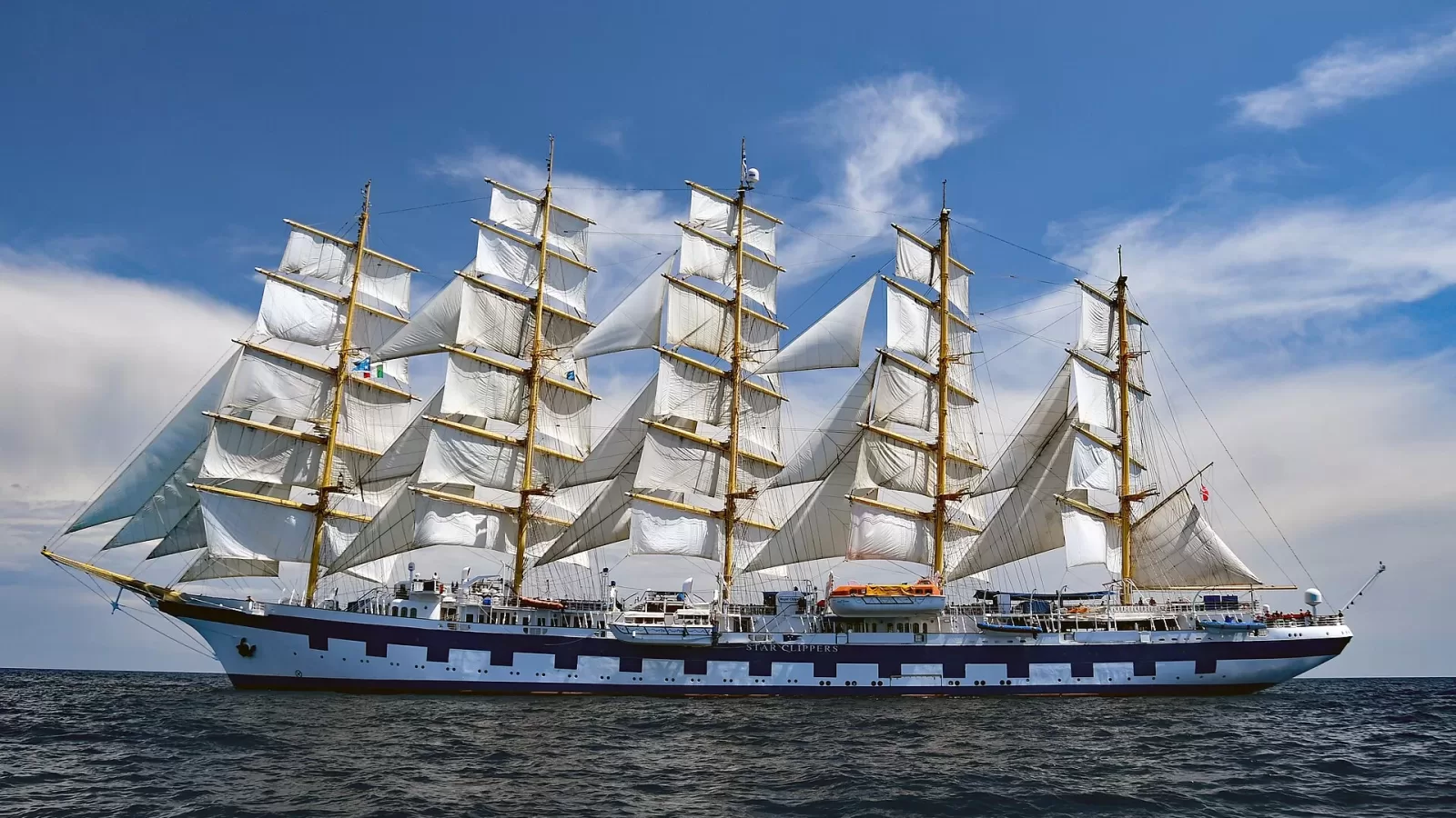 A tall sailing ship under sail at sea