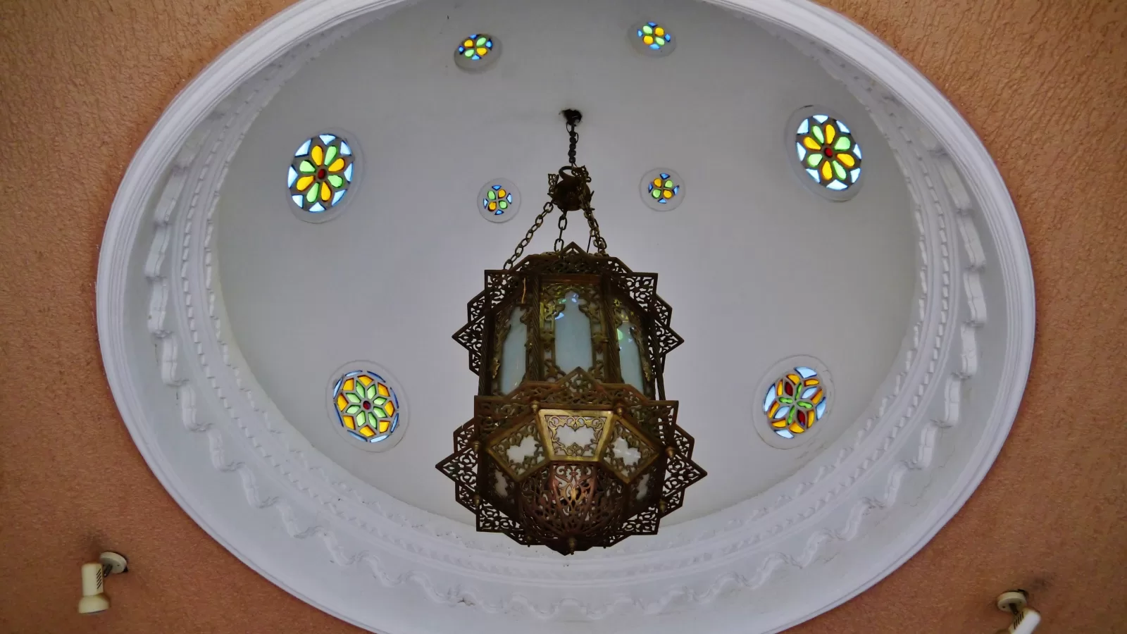 Plaster dome and hanging lantern inside a museum