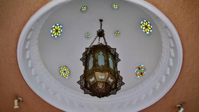 Plaster dome and hanging lantern inside a museum