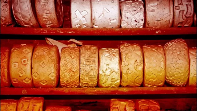 A row of terracotta pots on a shelf