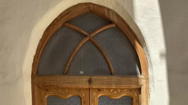 Old carved wooden door with arched glass in a Kuwaiti house