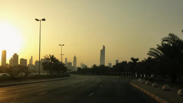 حركة السير على طريق في مدينة الكويت عند الغروب